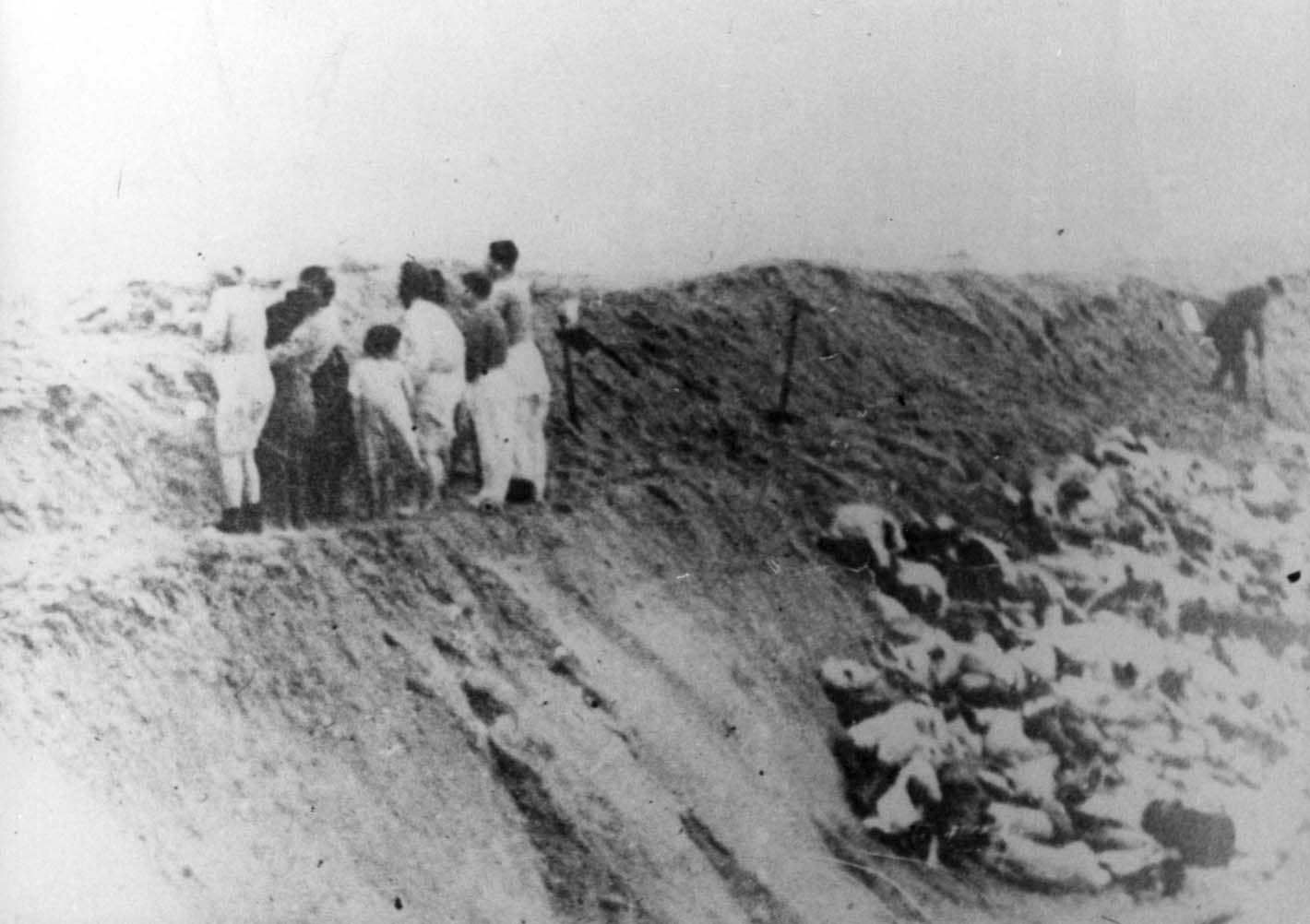 Jewish women and children from Liepaja stand on the edge of a pit before being murdered, December 15, 1941